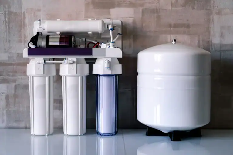 A complete multi-stage water filtration system with its separate storage tank is shown, highlighting the components of a home water solution available in Lake County, FL.